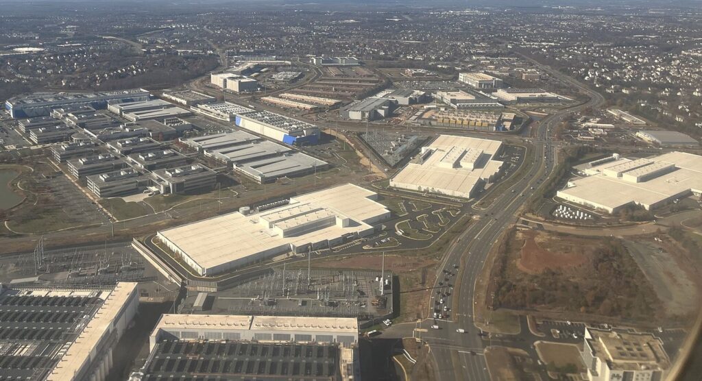 Aerial view of data centers, an electrical substation and roads among commercial buildings and neighborhoods in Loudoun County near Ashburn, Virginia