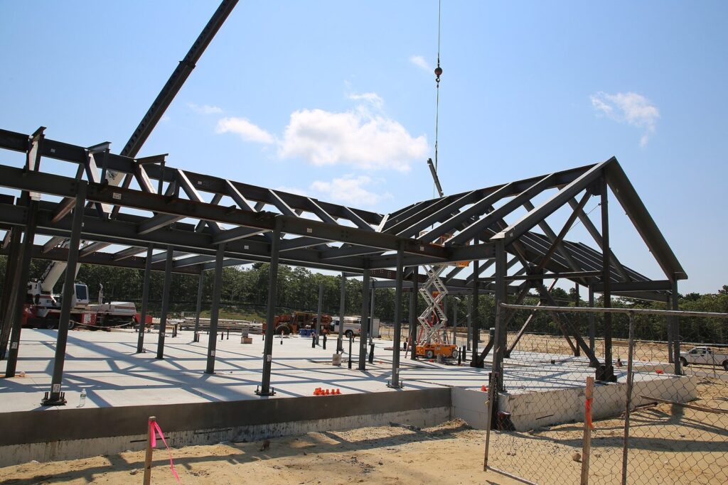 Steel framing rising on a concrete slab at the construction site of a skilled nursing residence in Edgartown, Massachusetts